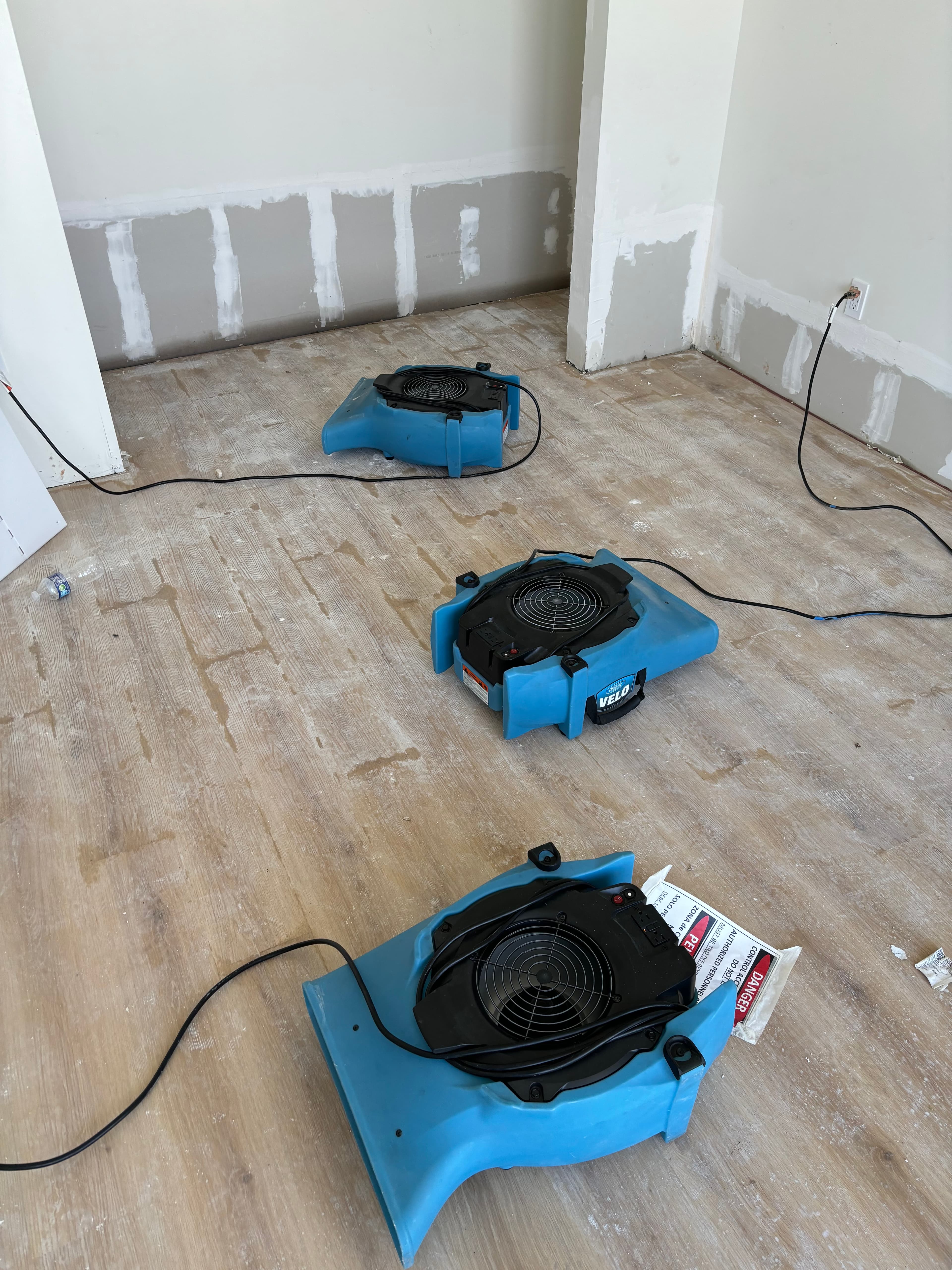 Three air movers running during water damage drying process